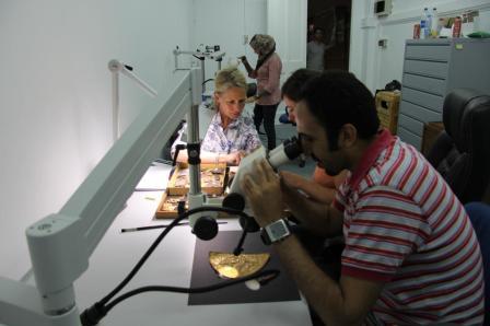 Gold relief panels under the microscope.